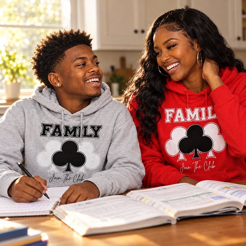 A mother and son laughing over homework in FAMILY club hoodies