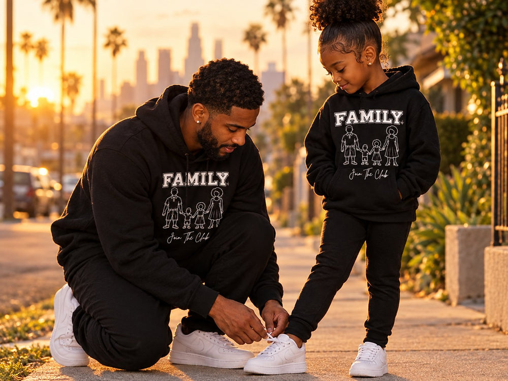 A father tying his daughter's shoe, both in FAMILY Join The Club hoodies