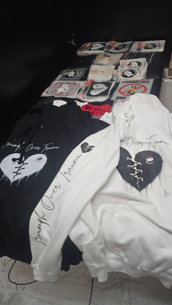 Triumph Over Trauma Mended Heart hoodies in black and white